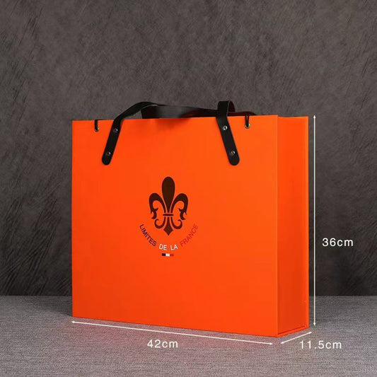 Orange paper wine gift bag with rope handle for carrying bottles