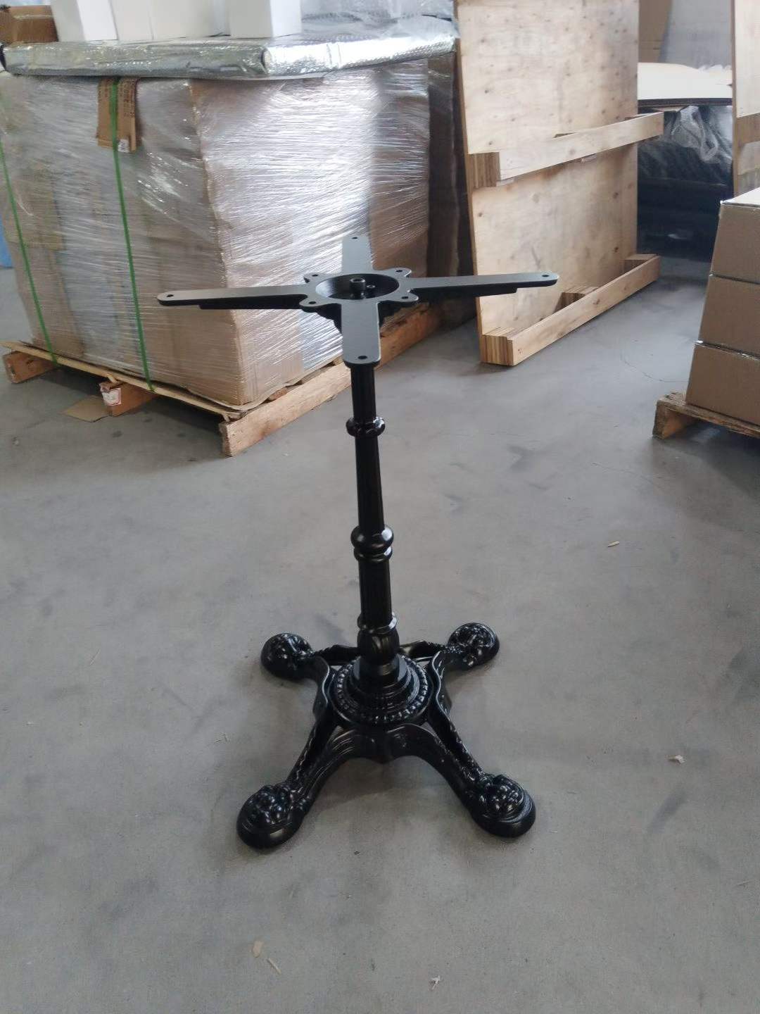 Cast iron four-leg table base with decorative column, side angle for cafe use