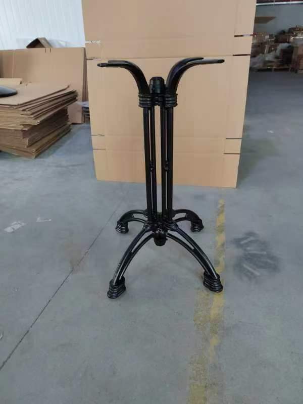 Black metal folding table frame with double columns and curved top supports, front view