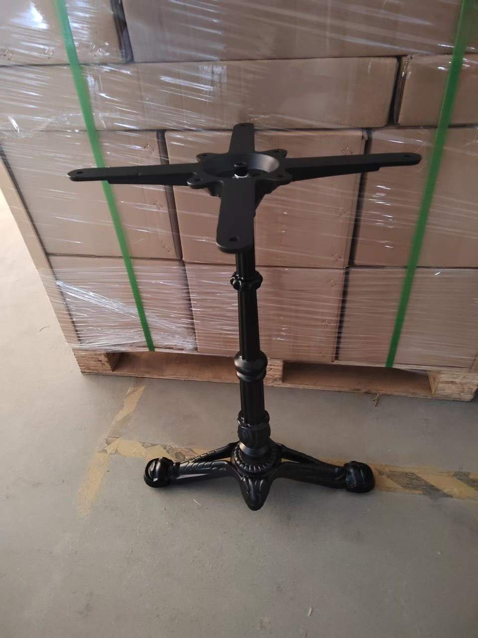 Black cast iron retro table base with four legs and decorative column, front view