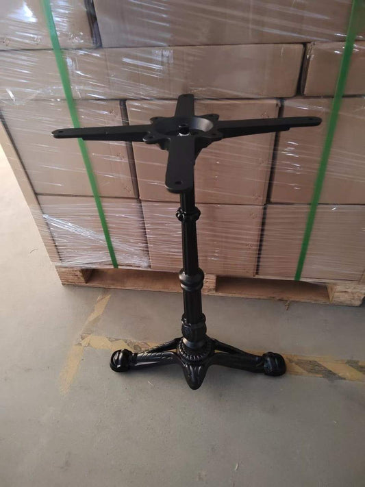 Black cast iron retro table base with four legs and decorative column, front view