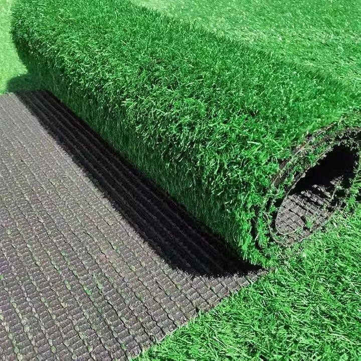 Green turf installation - Synthetic grass being laid outdoor scene