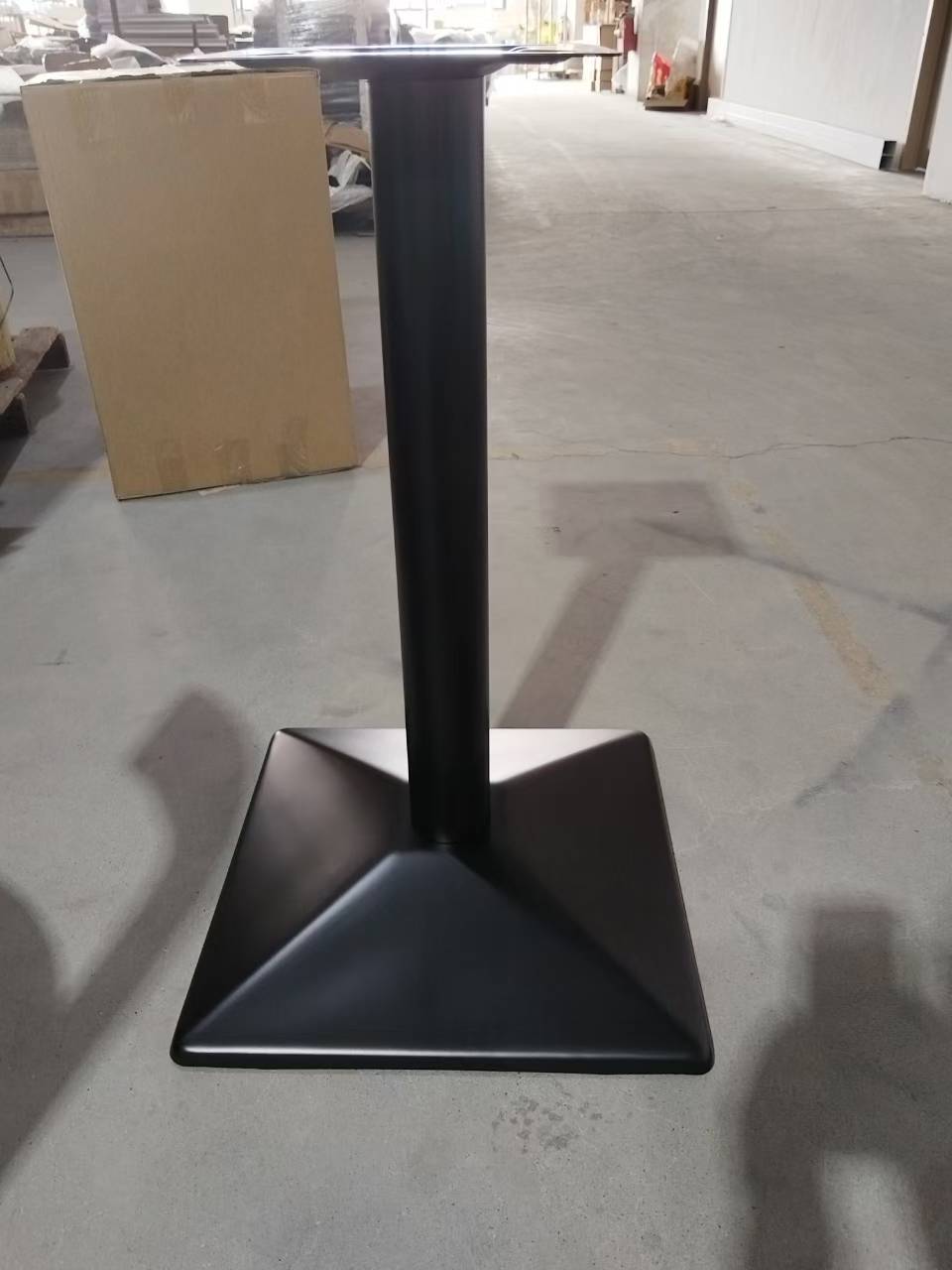 Black metal single column table base with square pyramid foot