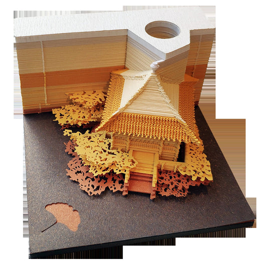 Front view of Chinese pavilion paper sculpture lamp with warm light glowing through carved trees