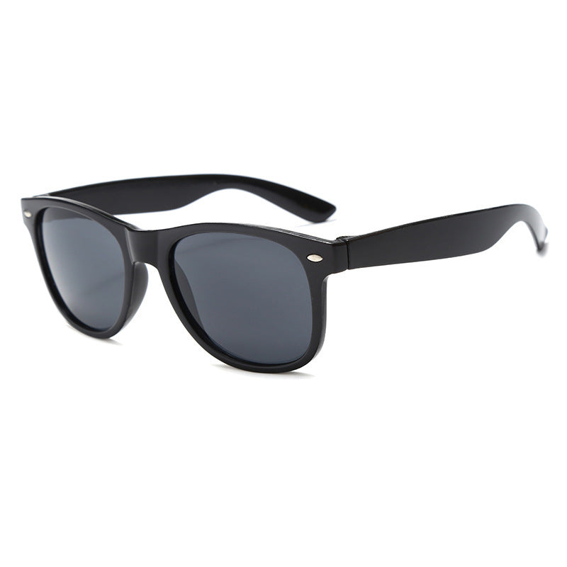 Classic plastic sunglasses with dark lenses and black retro frame on white background