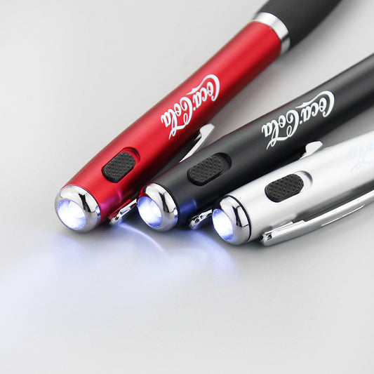 Close-up of the LED switch on the clip of the Coca-Cola promotional pen