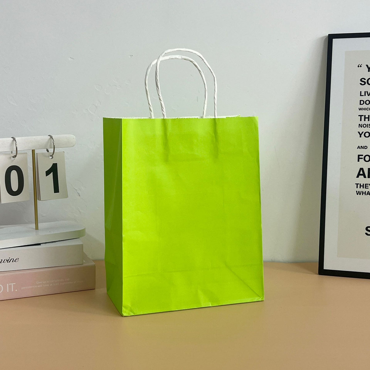 Colored paper tote bag filled with takeaway items on a cafe table