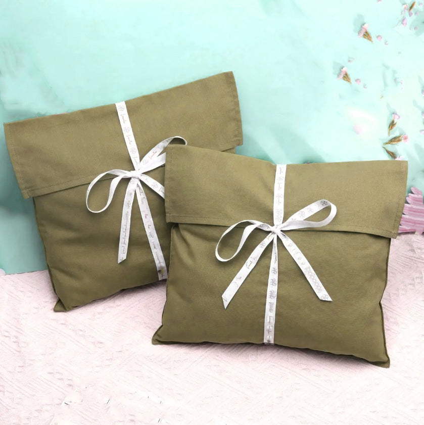 Canvas flap pouch with custom logo and ribbon tie, angled product shot