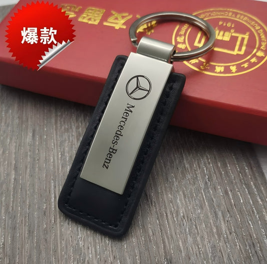 Tan leather keychain with brushed silver metal plate and stitched edges