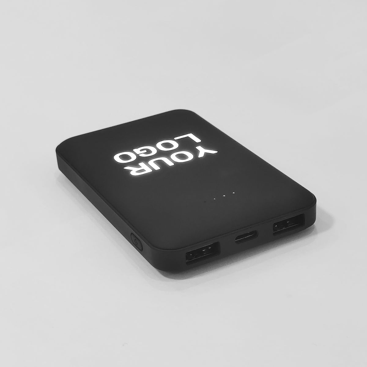 Front view of custom rectangular power bank showing illuminated logo and two USB charging ports
