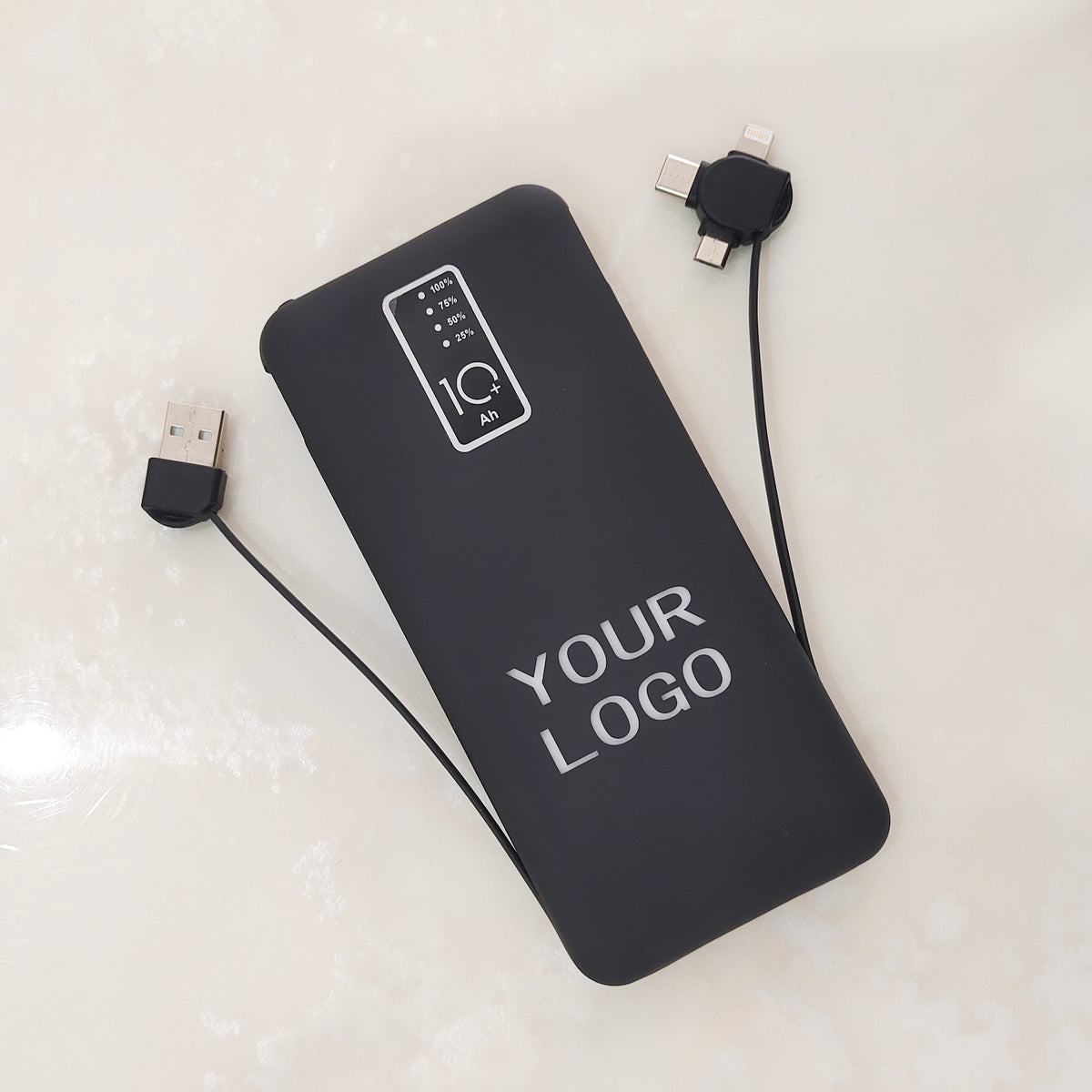 Rectangular power bank in matte black with glowing brand logo and side USB port detail