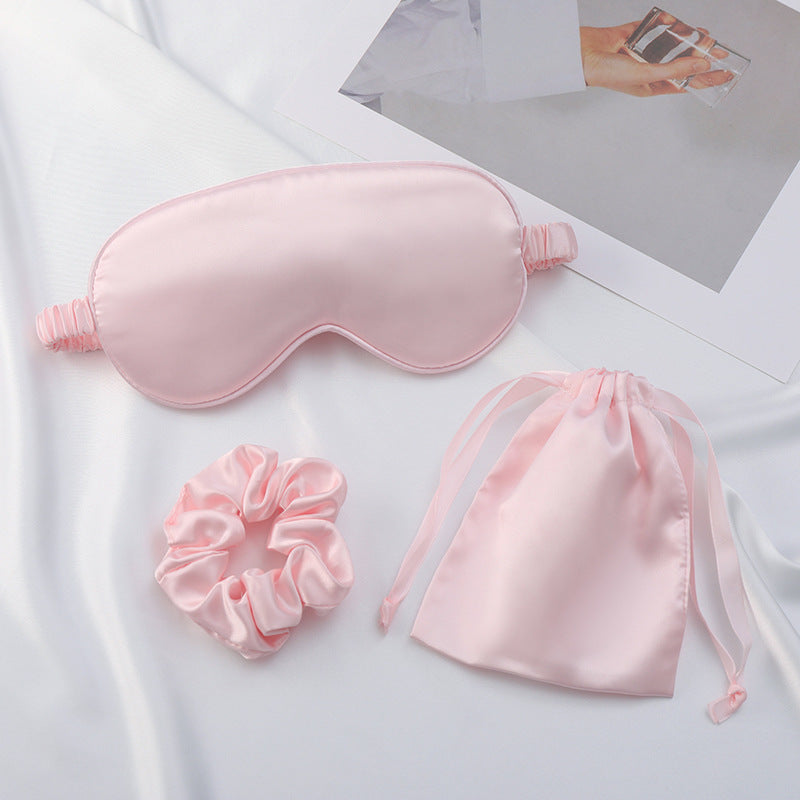Satin scrunchie in dusty rose shown next to matching eye mask