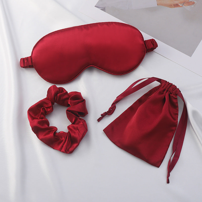 Drawstring pouch in champagne satin with the eye mask and scrunchie inside
