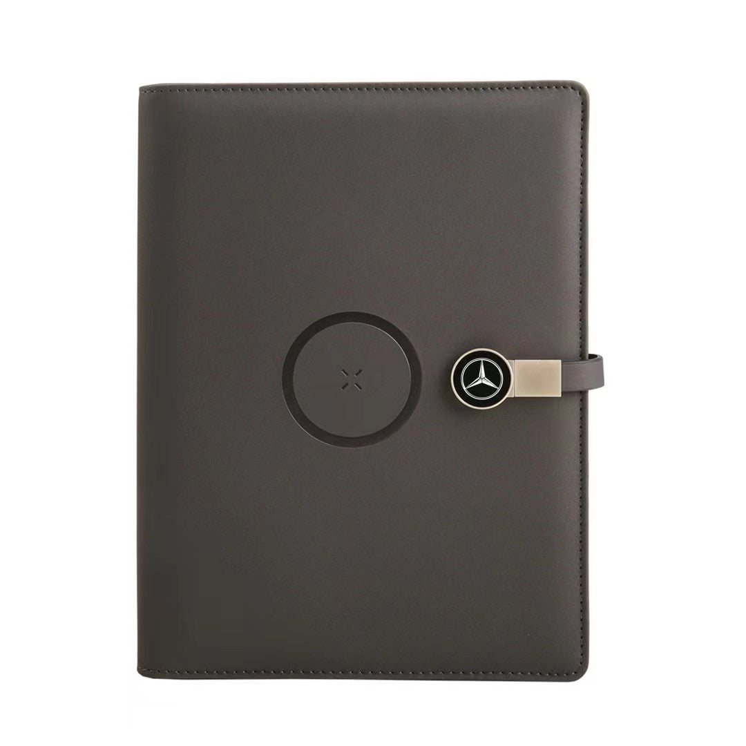 Wireless charging notebook showing phone charging on cover pad