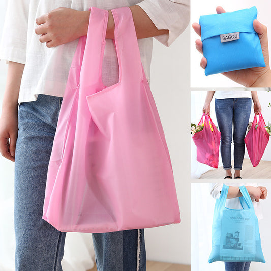 Close-up of the front pocket and stitched handle on a multi-color foldable shopping bag