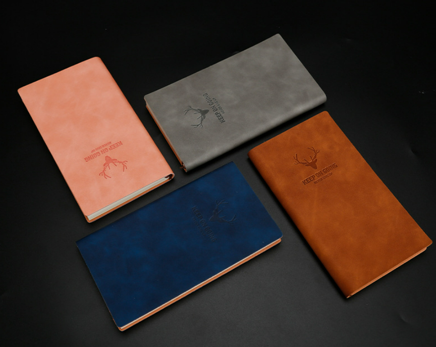 Navy blue leather notebook with deer-head logo and elastic closure band