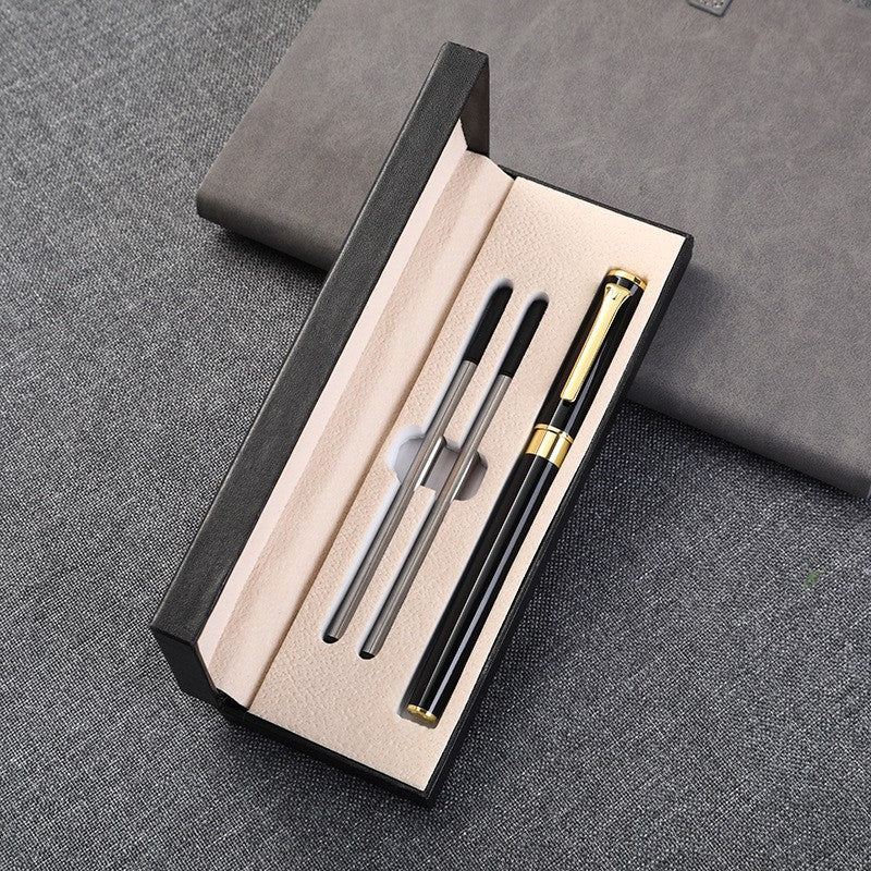 Open black leather pen gift box showing beige interior and silver pen inside