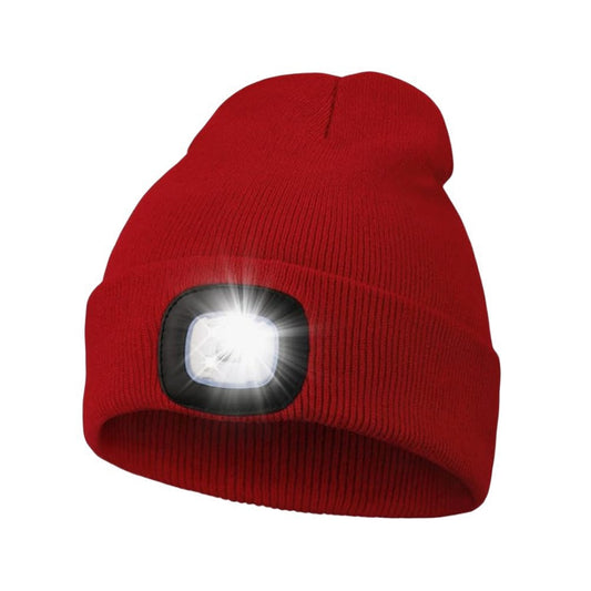 Close-up of the front LED light module on a knitted beanie, showing the USB rechargeable port