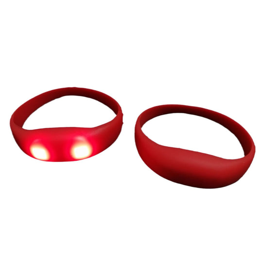 Multi-color LED silicone wristbands glowing in red, green and blue side by side