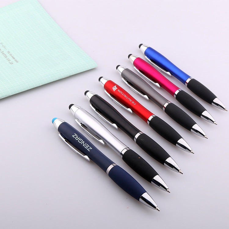 Close-up of black rubber grip and stylus tip on metal ballpoint pen