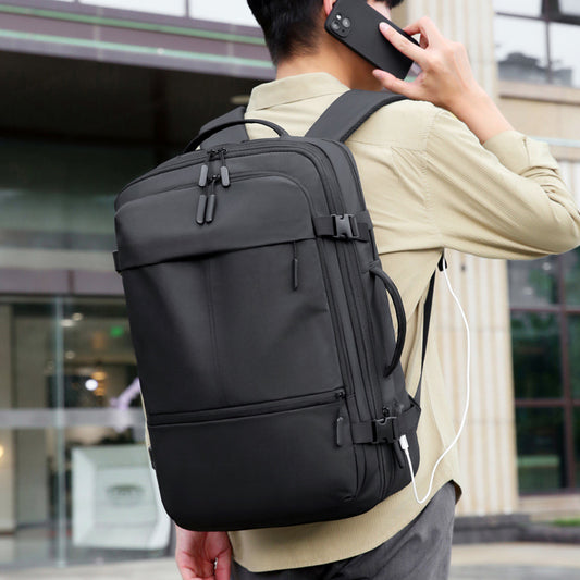 Business laptop backpack showing padded laptop compartment and compression straps
