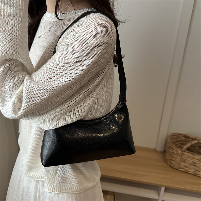 Glossy brown leather retro shoulder bag with adjustable strap and metal buckle detail