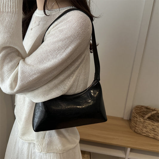 Glossy brown leather retro shoulder bag with adjustable strap and metal buckle detail