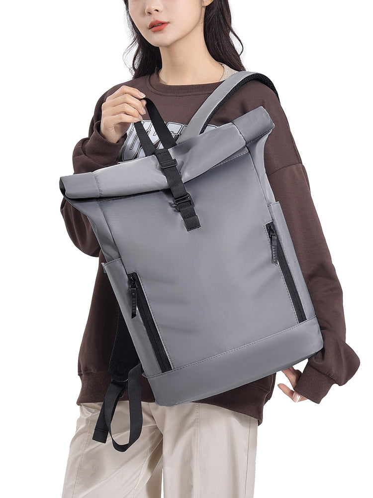 Roll-top backpack worn on back, showing capacity and comfortable straps