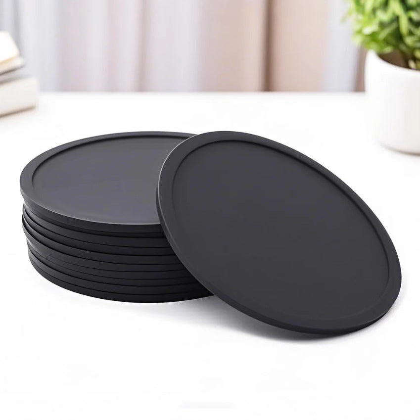 Round soft rubber coaster in solid dark color with raised rim on white background
