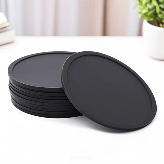 Round soft rubber coaster in solid dark color with raised rim on white background