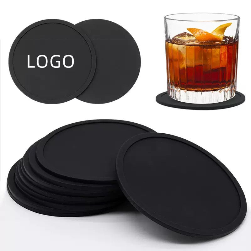 Single round rubber coaster with raised lip holding a glass of water
