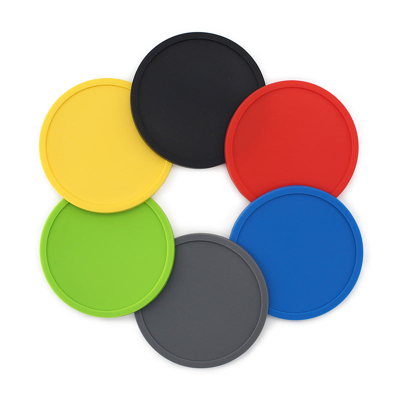 Round rubber coaster in bright solid color with raised rim viewed from above