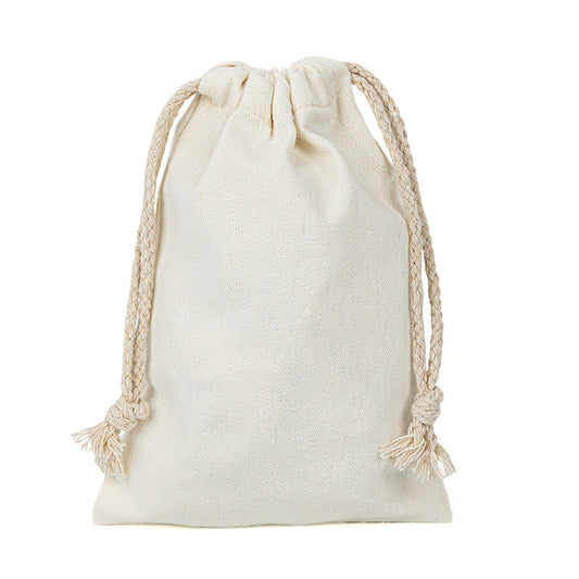 Solid color canvas drawstring pouch in a light neutral tone with a simple drawstring closure