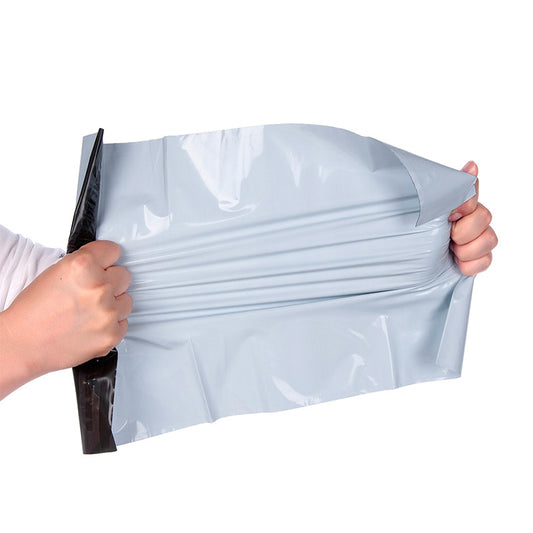 Close-up of the self-adhesive seal strip on a white poly mailer bag